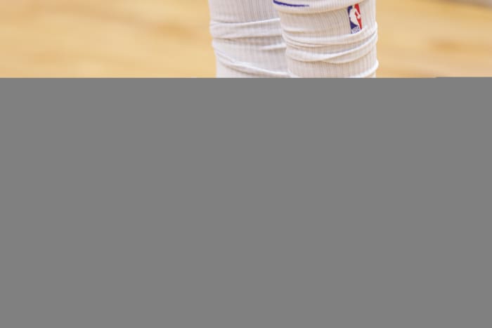 View of blue, white, and yellow Jordan Luka shoes.